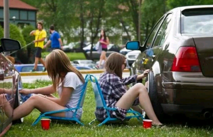 Two lovely girl washing cars